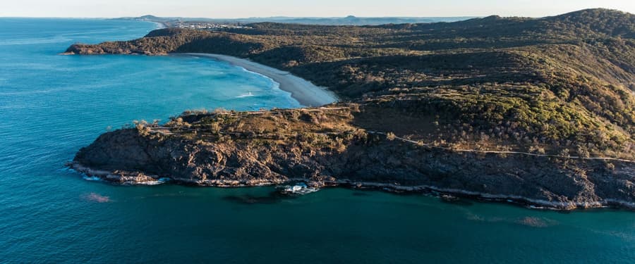 The Queensland coastline from the air, with headland and beach